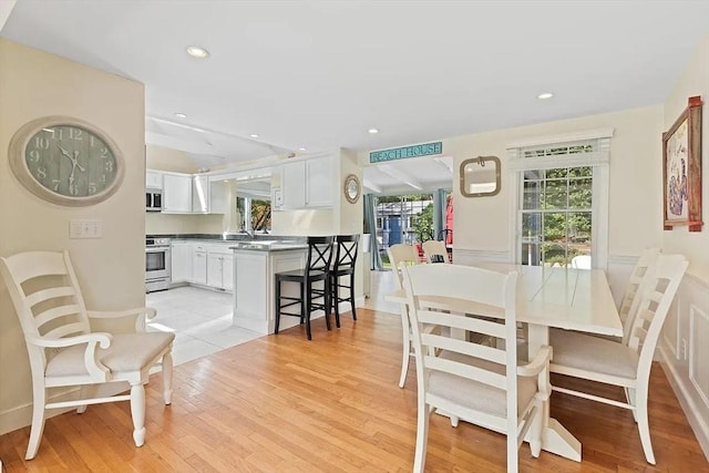 4 Wildwood Ave, Harwich, MA 02645 - dining area with light wood-style flooring, wainscoting, and recessed lighting