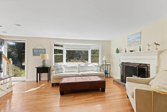 4 Wildwood Ave, Harwich, MA 02645 - living room with light wood finished floors and a fireplace with raised hearth