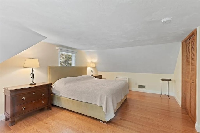 4 Wildwood Ave, Harwich, MA 02645 - bedroom featuring light wood finished floors, vaulted ceiling, and a closet