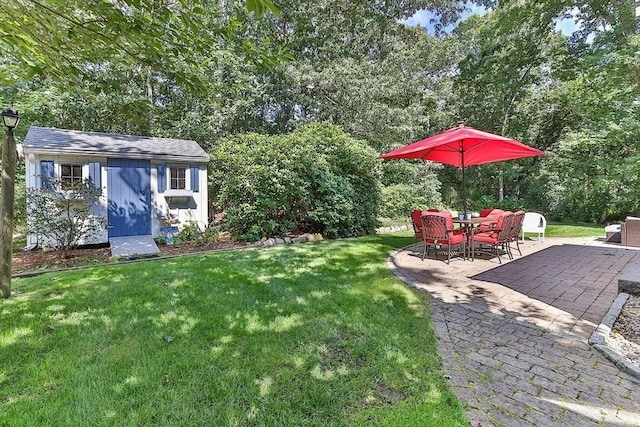 4 Wildwood Ave, Harwich, MA 02645 - view of green lawn with a storage shed, a patio, and view of wooded area