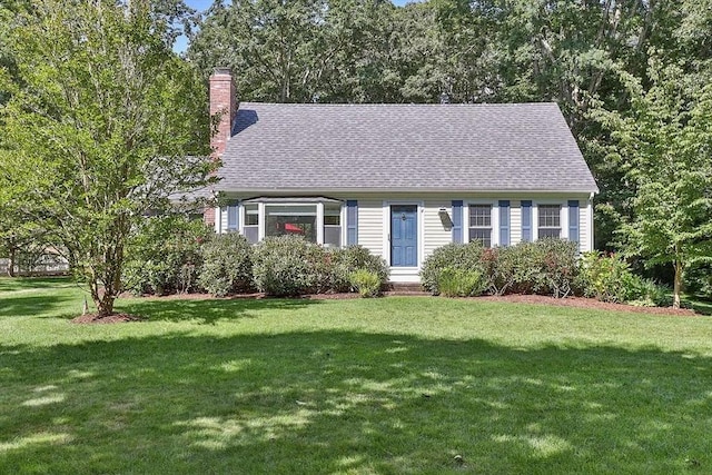 4 Wildwood Ave, Harwich, MA 02645 - cape cod house featuring a front lawn, a chimney, and roof with shingles