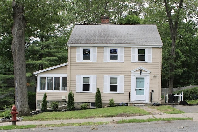 49 Newcomb Rd, Stoneham, MA 02180 - colonial inspired home featuring a chimney, a shingled roof, and view of wooded area