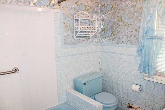 49 Newcomb Rd, Stoneham, MA 02180 - bathroom with wallpapered walls, tile walls, a bathtub, and wainscoting