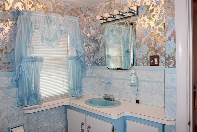 49 Newcomb Rd, Stoneham, MA 02180 - bathroom with vanity, tile walls, wallpapered walls, and a wainscoted wall