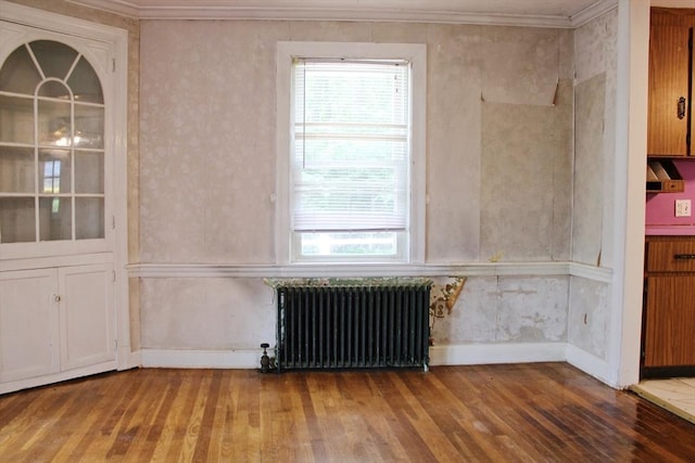 49 Newcomb Rd, Stoneham, MA 02180 - unfurnished room featuring radiator, wood finished floors, plenty of natural light, and ornamental molding