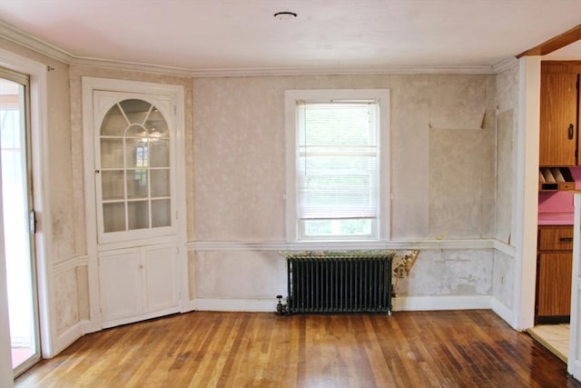 49 Newcomb Rd, Stoneham, MA 02180 - unfurnished dining area with radiator heating unit, hardwood / wood-style flooring, healthy amount of natural light, and ornamental molding