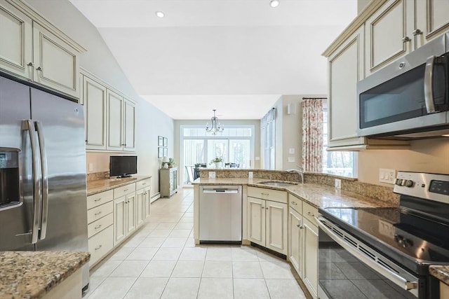 kitchen featuring sink, stainless steel appliances, and cream cabinetry