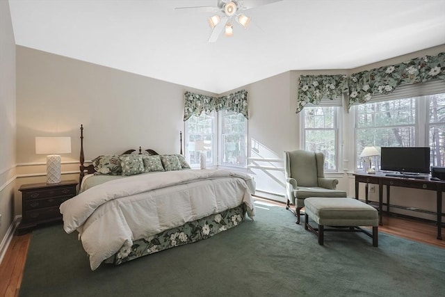 bedroom with dark hardwood / wood-style floors and ceiling fan