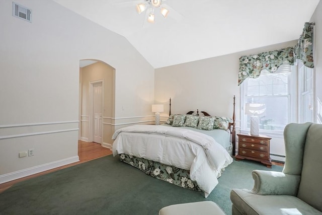 bedroom featuring vaulted ceiling, hardwood / wood-style floors, ceiling fan, and a baseboard radiator