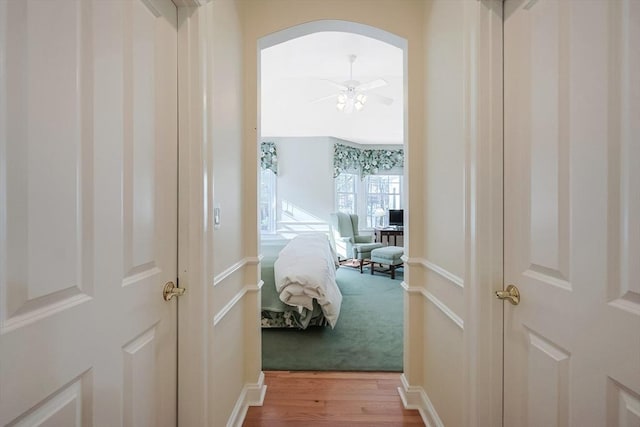 corridor with hardwood / wood-style flooring