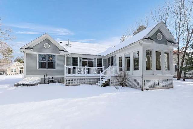 view of snow covered rear of property