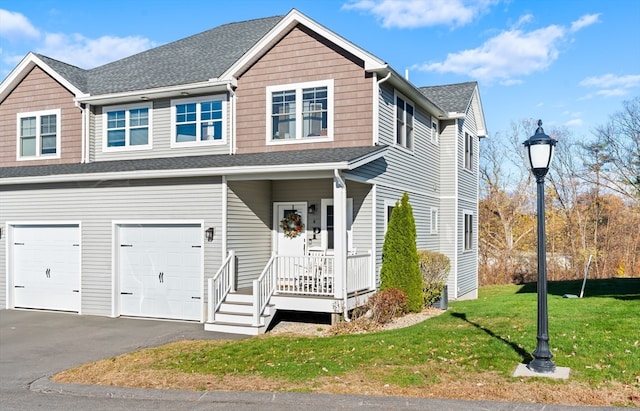 view of front facade with a front lawn, a garage, and a porch