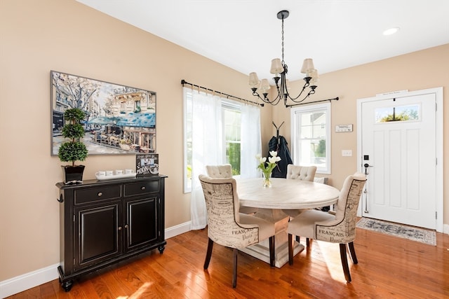 dining area with an inviting chandelier and light wood-type flooring