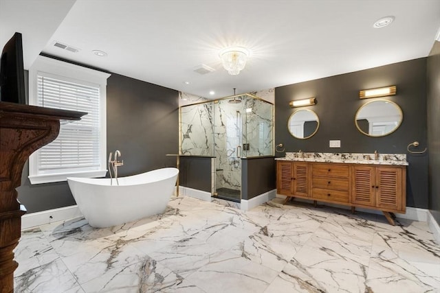 full bath with a marble finish shower, baseboards, a freestanding tub, marble tiled floors, and double vanity