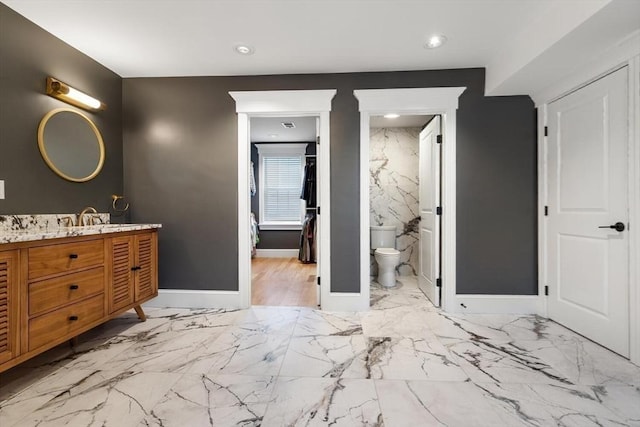 full bath with toilet, marble finish floors, vanity, baseboards, and recessed lighting