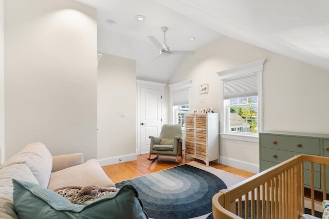 bedroom featuring vaulted ceiling, wood finished floors, baseboards, and ceiling fan