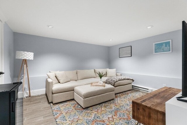 living room featuring a baseboard radiator, wood finished floors, recessed lighting, and baseboards