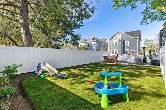 view of yard with cooling unit and a patio area