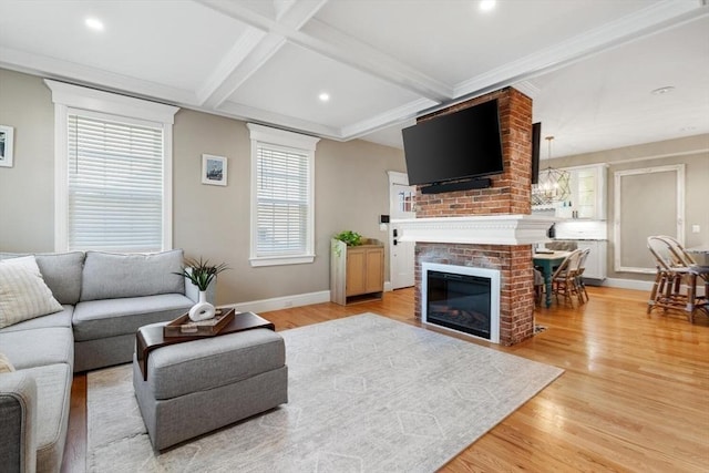 living area featuring a brick fireplace, beamed ceiling, light wood-type flooring, recessed lighting, and baseboards