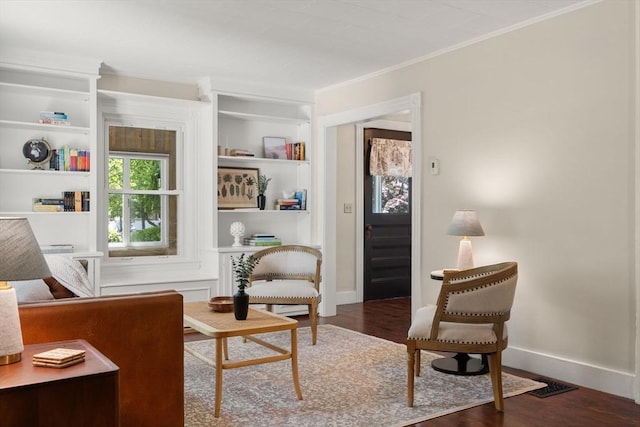 23 Hanson St, Wakefield, MA 01880 - living area with wood finished floors, ornamental molding, baseboards, and built in shelves