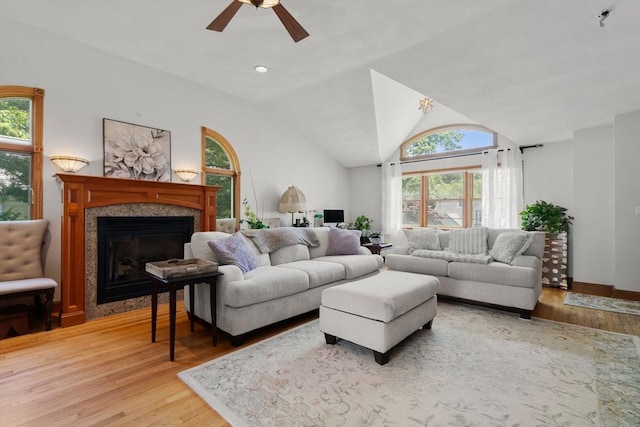 23 Hanson St, Wakefield, MA 01880 - living room with light wood-type flooring, ceiling fan, a glass covered fireplace, and lofted ceiling