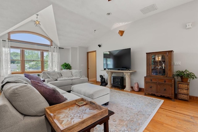 23 Hanson St, Wakefield, MA 01880 - living area featuring lofted ceiling, light wood-style floors, a fireplace, and baseboards