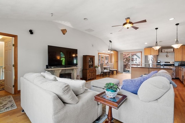 23 Hanson St, Wakefield, MA 01880 - living area with lofted ceiling, light wood-type flooring, ceiling fan, a fireplace, and recessed lighting