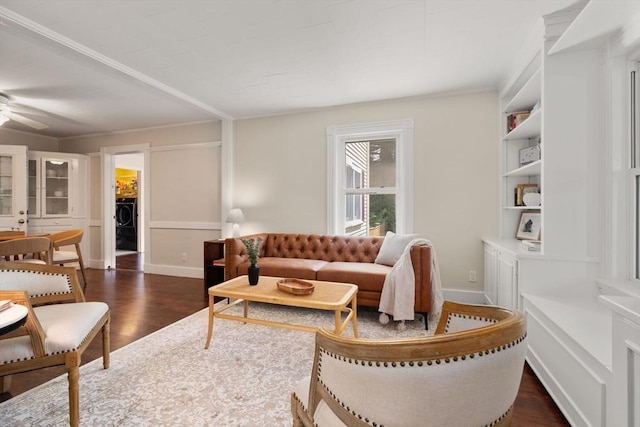 23 Hanson St, Wakefield, MA 01880 - living area featuring dark wood-type flooring, ceiling fan, washer / clothes dryer, baseboards, and ornamental molding