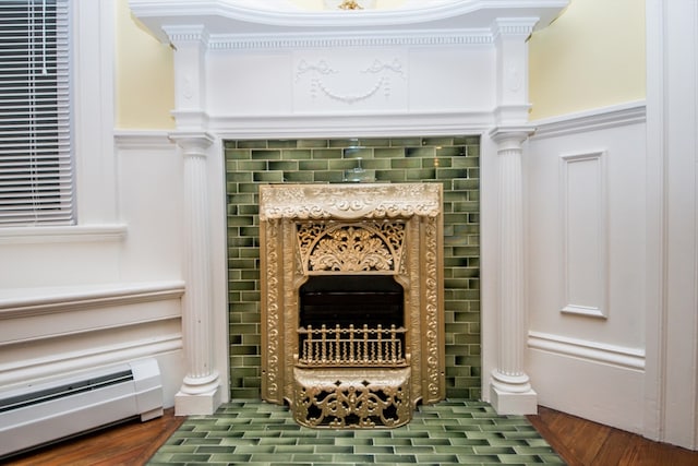 details featuring wood-type flooring, baseboard heating, and ornamental molding