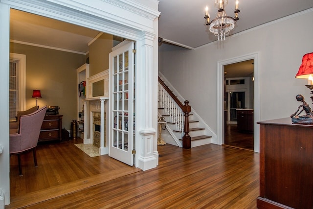 interior space featuring ornamental molding, dark wood-type flooring, and a notable chandelier