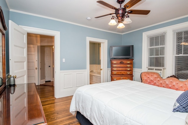 bedroom with ensuite bath, ceiling fan, hardwood / wood-style floors, and ornamental molding