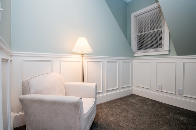 living area featuring dark carpet