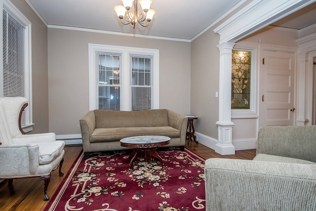 living room featuring ornate columns, crown molding, a baseboard heating unit, and hardwood / wood-style flooring