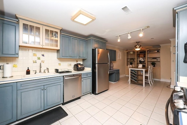 kitchen featuring ornamental molding, appliances with stainless steel finishes, sink, and decorative backsplash