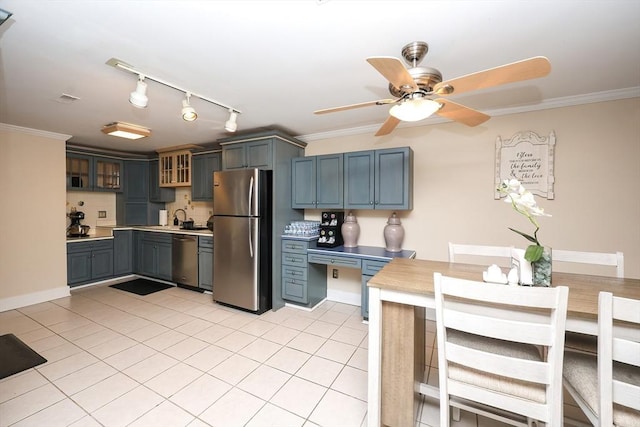 kitchen featuring crown molding, appliances with stainless steel finishes, light tile patterned floors, and ceiling fan