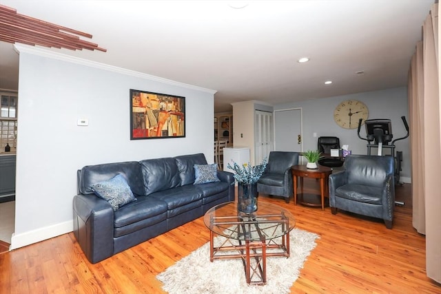 living room with crown molding and hardwood / wood-style flooring