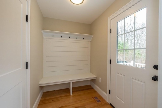 mudroom with light wood-style floors, baseboards, and visible vents