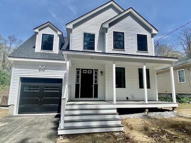 view of front of home with a garage, aphalt driveway, and covered porch