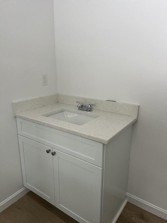 bathroom with vanity and wood-type flooring