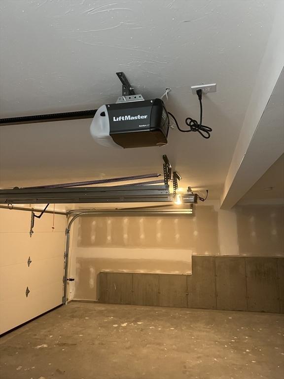 room details featuring a garage door opener and concrete floors