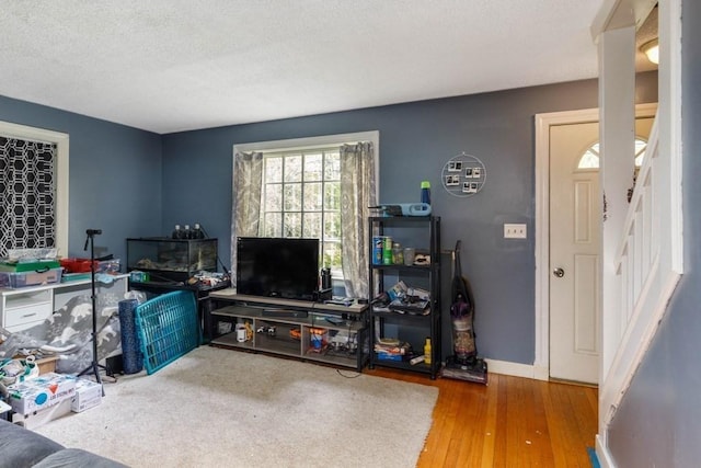 174 Pleasant St, Paxton, MA 01612 - living area with a textured ceiling and wood finished floors
