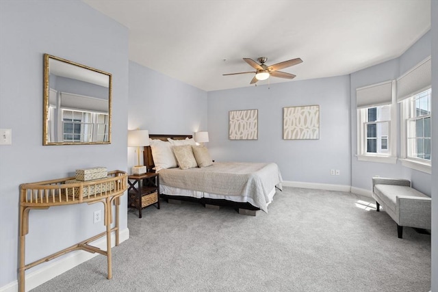 carpeted bedroom with baseboards and a ceiling fan