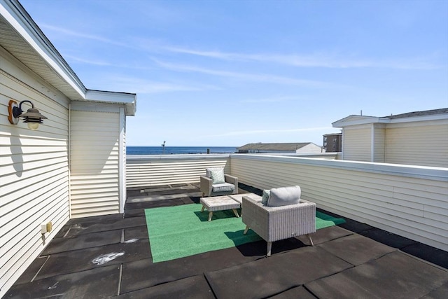 view of patio featuring a water view and a balcony