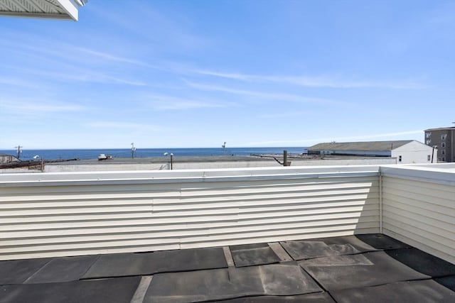 view of patio with a water view and a balcony
