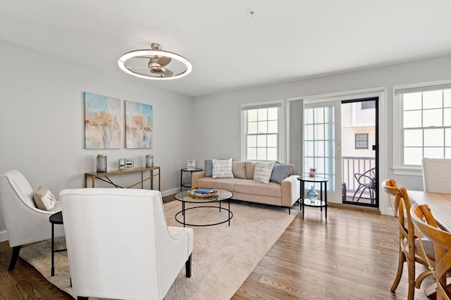 living area with wood finished floors and baseboards