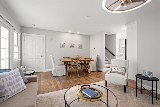 dining area with stairs, wood finished floors, baseboards, and recessed lighting
