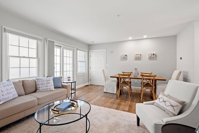 living room with wood finished floors, recessed lighting, and baseboards