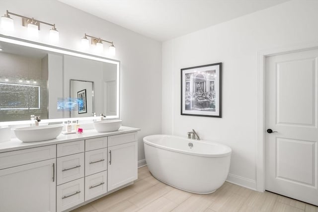 bathroom featuring vanity and a bath