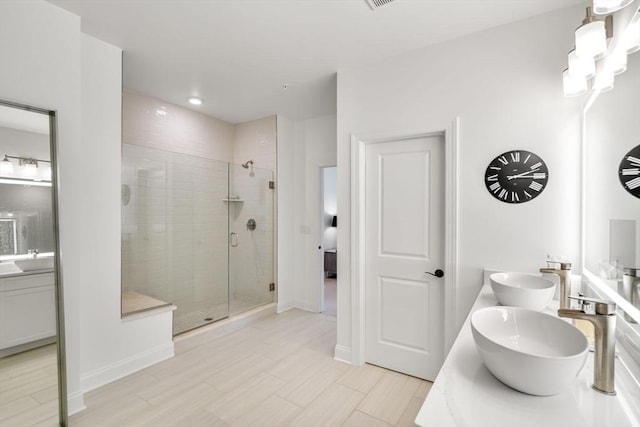 bathroom featuring vanity and an enclosed shower