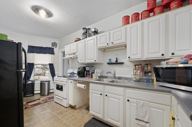 186 Summit St, Pawtucket, RI 02860 - kitchen featuring stainless steel microwave, white gas range, freestanding refrigerator, a sink, and white cabinetry
